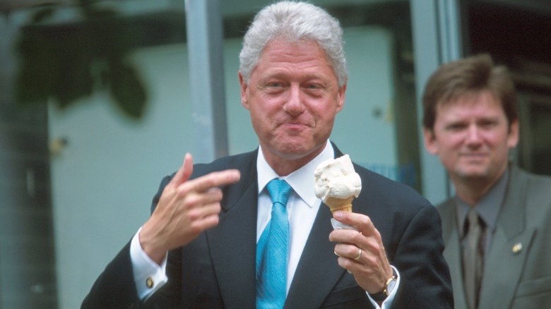 Bill Clinton holding a cone of vanilla ice cream.