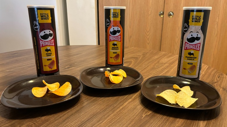Pringles and Buffalo Wild Wings chips on plate on brown table in array