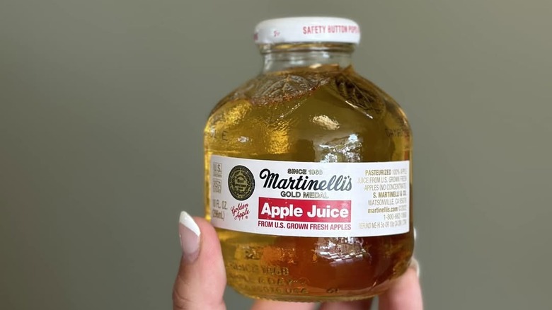 Someone holding a Martinelli's apple juice