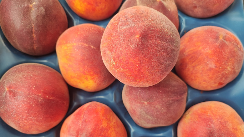 a container of peaches also known as stone fruit