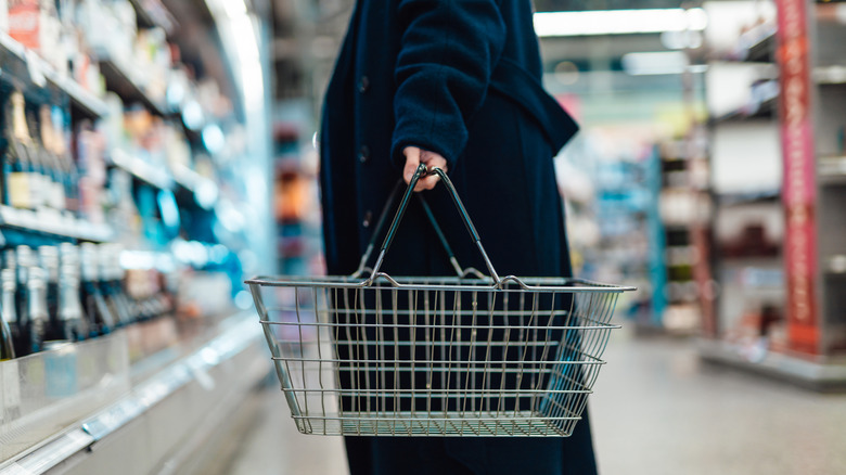 A woman deciding where to buy her groceries