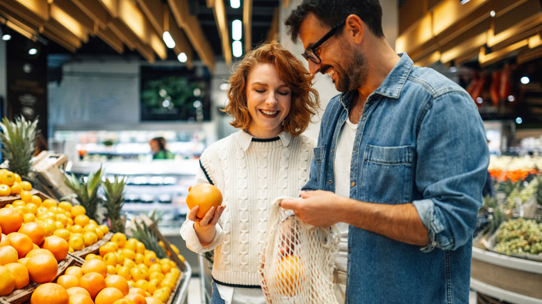 Couple buying produce at the grocery store