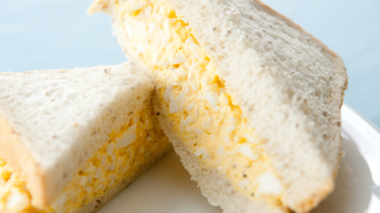 An egg salad sandwich on white bread