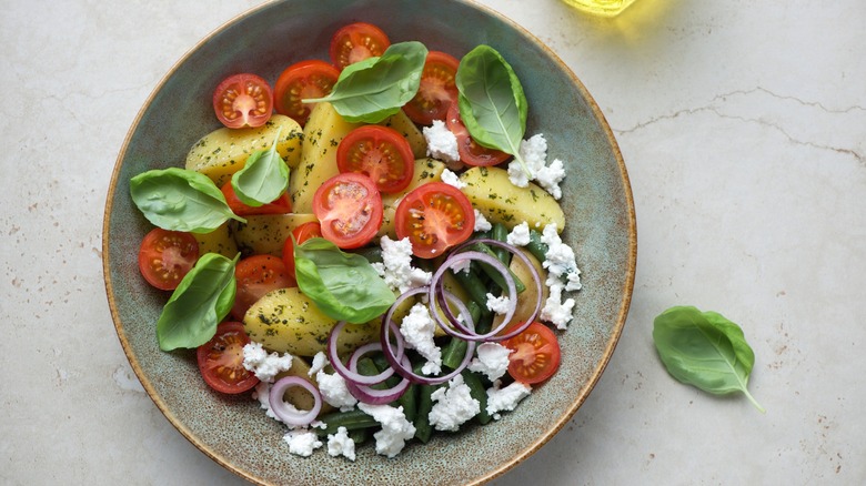 Italian potato salad with cherry tomatoes, green beans, and ricotta