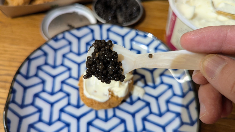 mother of pearl spoon with caviar on top of chicken mcnugget