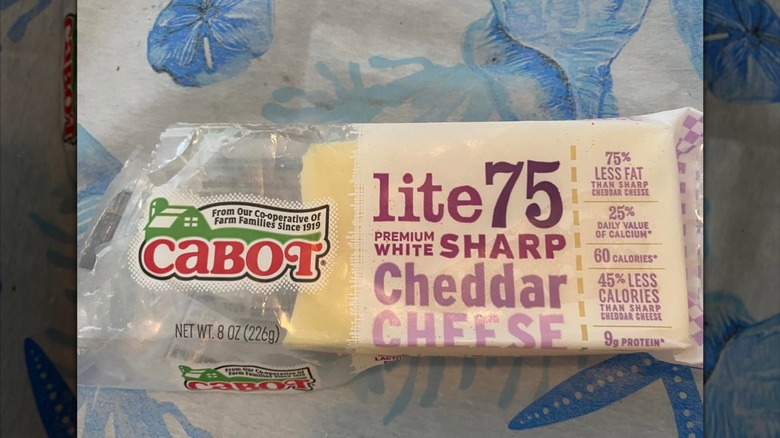 An open package of Cabot brand low fat Cheddar cheese.