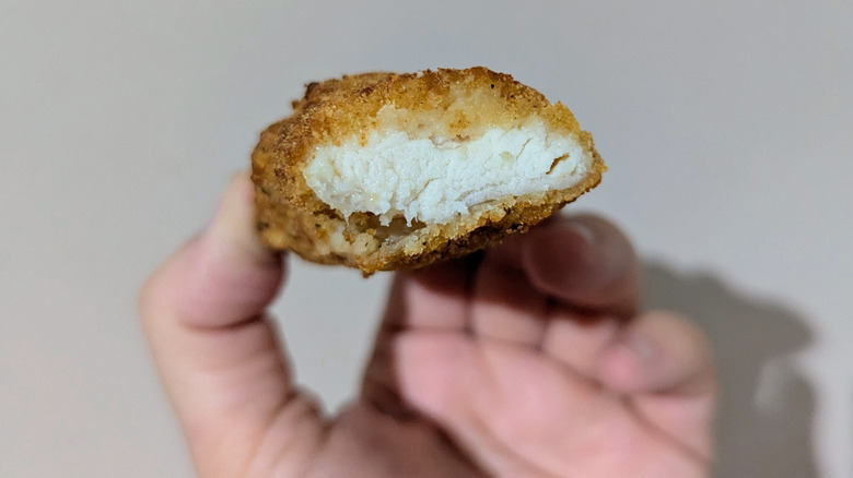Holding a cross section of a QVC chicken tender