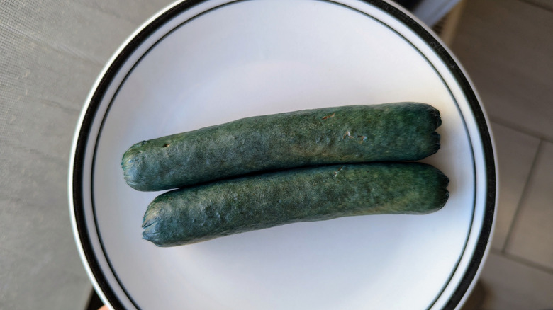 Two Gatorade boiled hot dogs on small plate.
