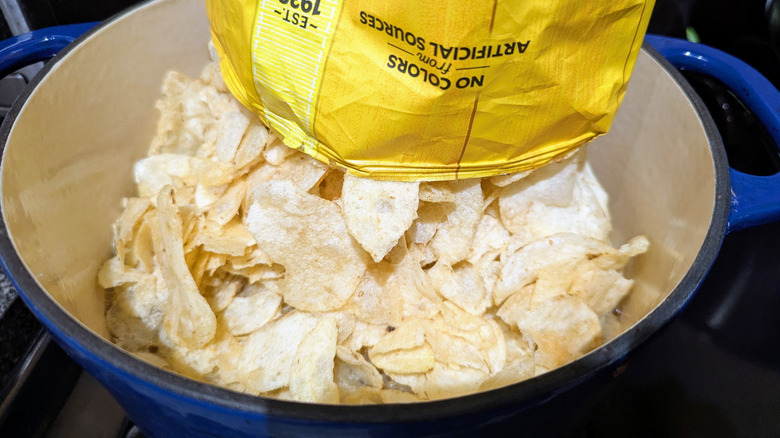 A bag of Lay's Original potato chips inverted into Dutch oven.