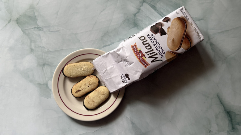 Milano Double Dark Chocolate cookies on a plate beside the bag