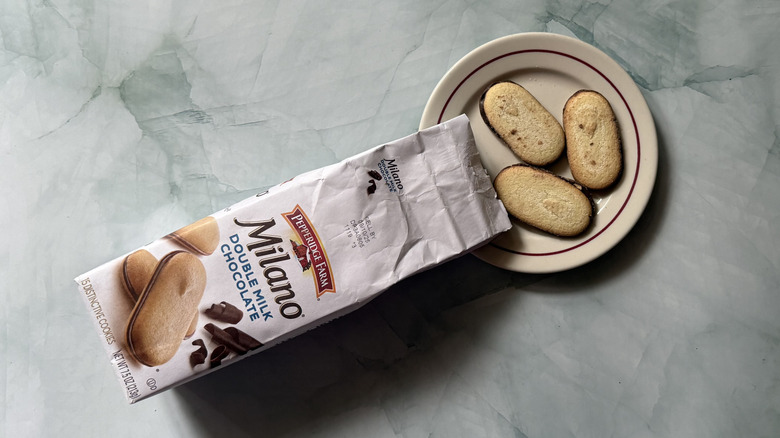 Milano Double Milk Chocolate cookies on a plate beside the bag
