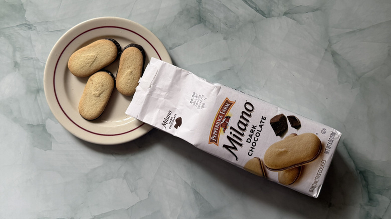 Milano Dark Chocolate cookies on a plate beside the bag