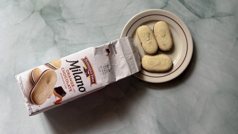 Milano Orange Chocolate cookies on a plate beside the bag