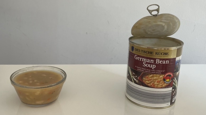 A can and bowl of German bean soup sit on a counter