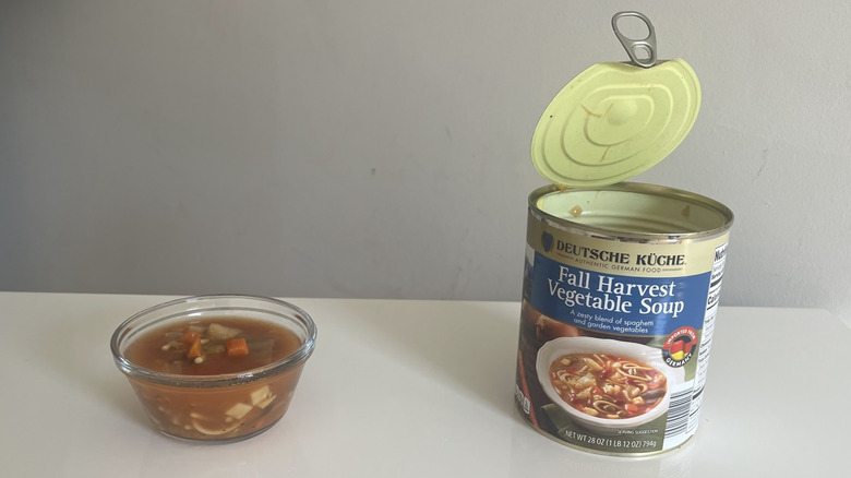 A can and bowl of fall harvest soup sit on a counter