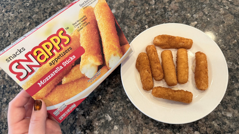 Snapps mozzarella sticks on a plate next to box