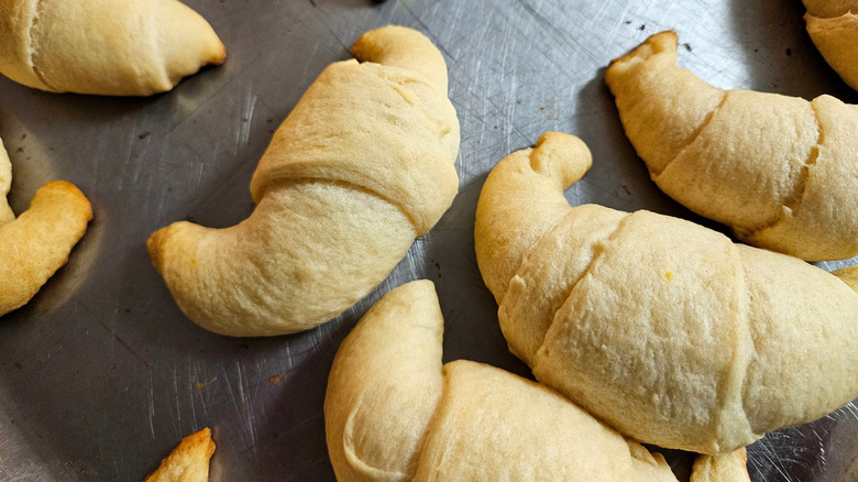 Underbaked canned crescent rolls on a baking sheet