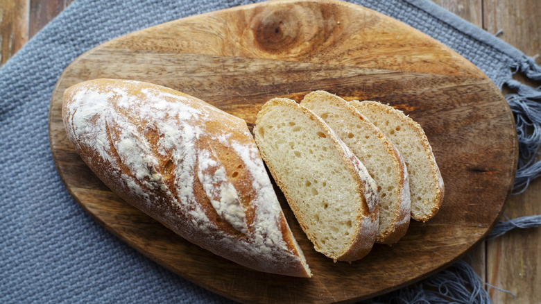 A sliced loaf of bread on a wooden board