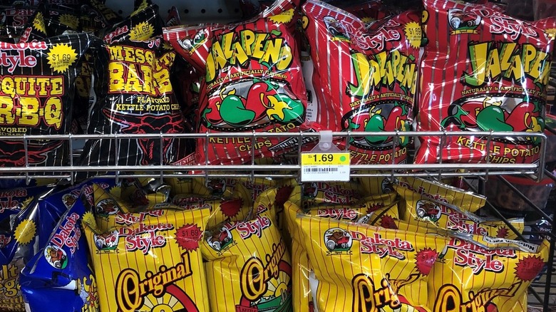 several colorful bags of Dakota Style chips on store rack