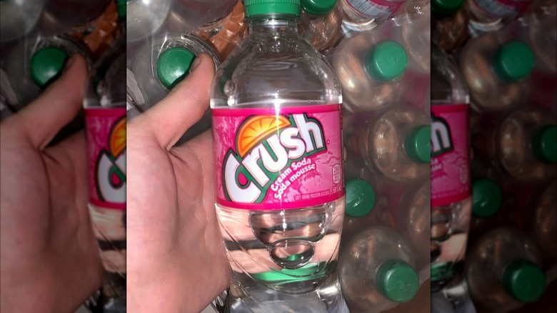 Hand holding bottle of Crush Cream Soda