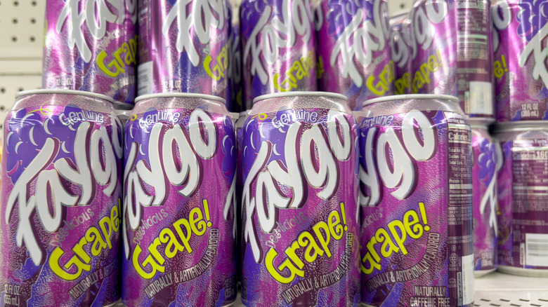 Cans of grape Faygo on store shelf