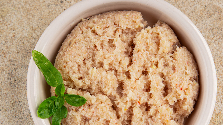 Canned crab meat in a white bowl, viewed from above