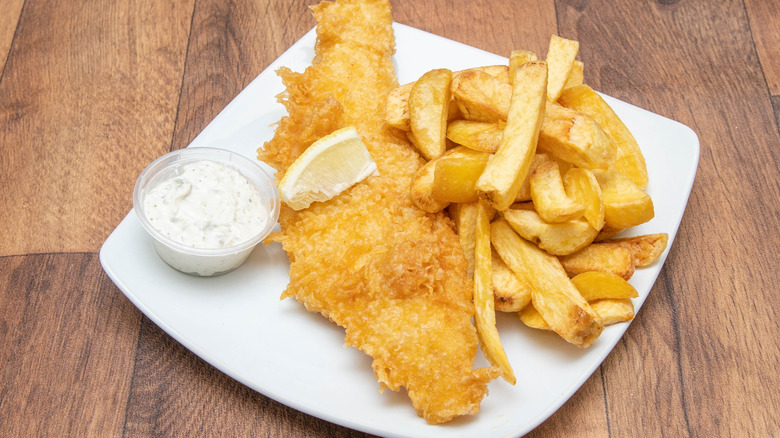Fish and chips and tartar sauce on plate