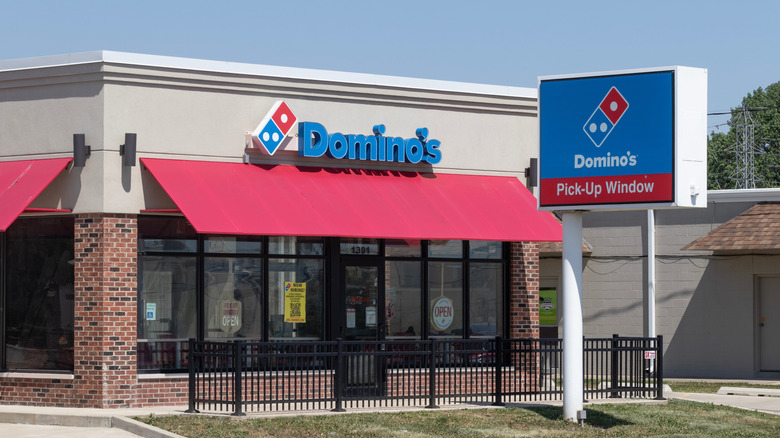 A Domino's Pizza restaurant with a pick up window