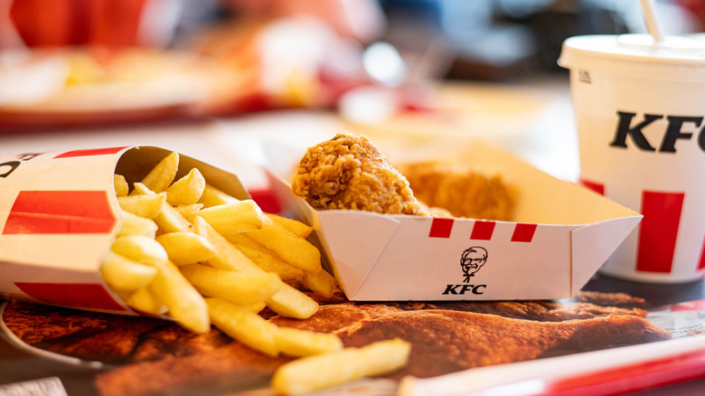 A KFC meal of fried chicken, fries, and a drink
