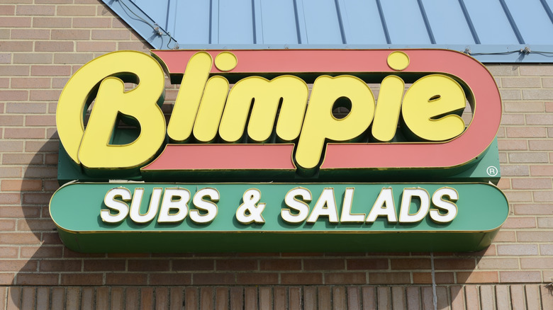 A Blimpie restaurant sign on a brick building that read Blimpie Subs & Salads