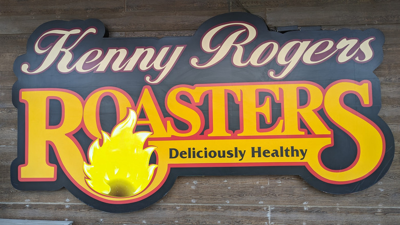 a restaurant sign that reads Kenny Rogers Roasters, Deliciously Healthy
