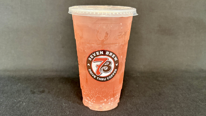Fizzy red 7 Brew drink in clear cup