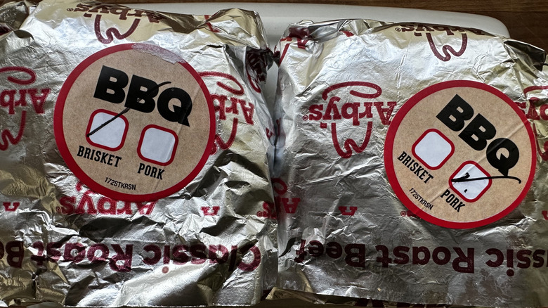 Arby's Quarter Pound brisket and pulled pork sandwiches in wrappers