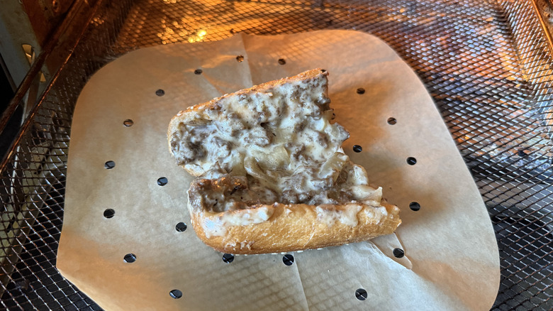 half of an Arby's cheesesteak sandwich in an air fryer