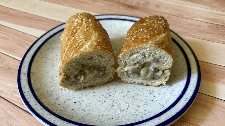 Halved cheesesteak from Arby's on a plate