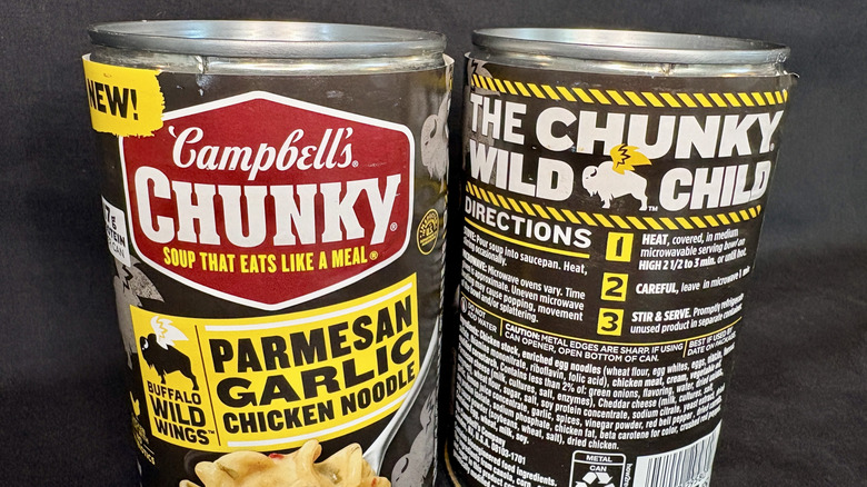 Close up of cans of Campbell's Chunky Buffalo Wild Wings Parmesan Garlic Chicken Noodle Soup front and back
