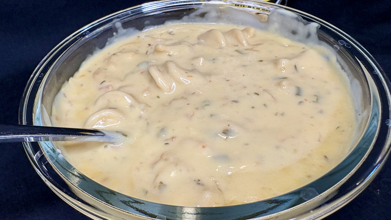 Glass bowl of creamy Campbell's Chunky Buffalo Wild Wings Garlic Parmesan Chicken Noodle Soup