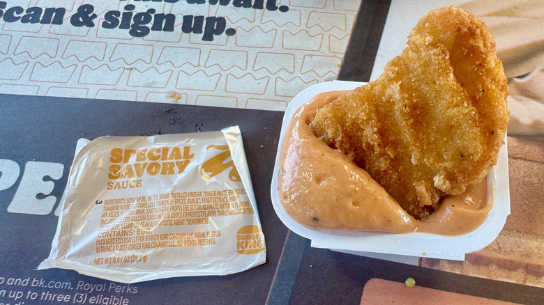 A nugget dipped in a light orange special savory sauce.