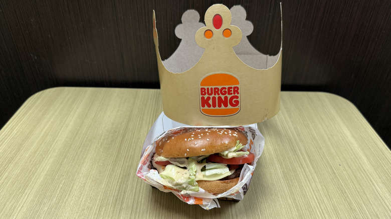 A paper crown rests near the Peppercorn BLT Whopper