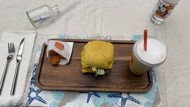 Tater tots, Krabby Whopper, and a float from Burger King on wooden tray