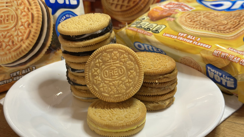 All three new Oreo flavors together on a white plate in three stacks with packages in the background