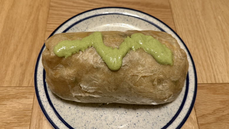 Chipotle's Cilantro Lime Sauce drizzled on top of a burrito