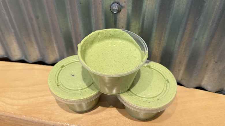 three cups of Chipotle's Cilantro Lime Sauce
