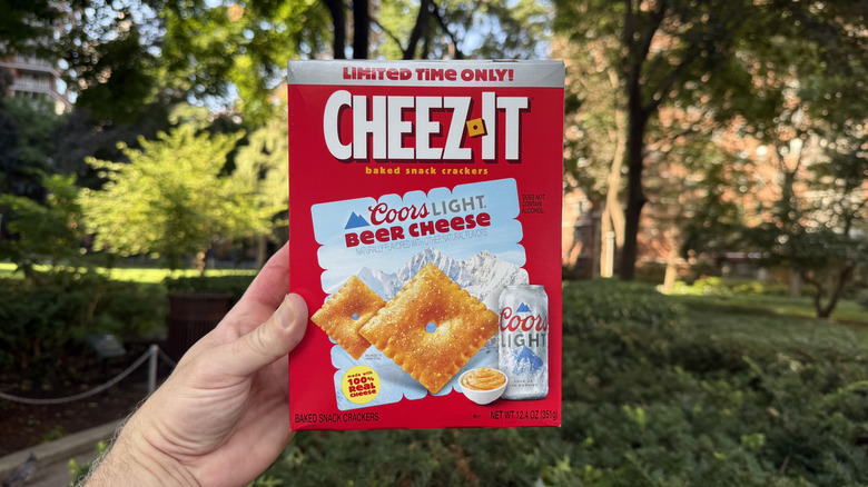 A box of Cheez-It Coors Light Beer Cheese held in the air