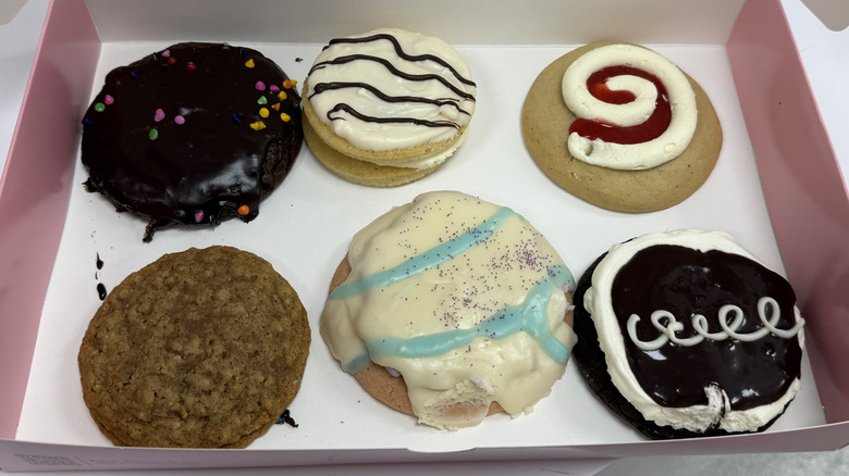An open box of six Crumbl x Little Debbie cookies