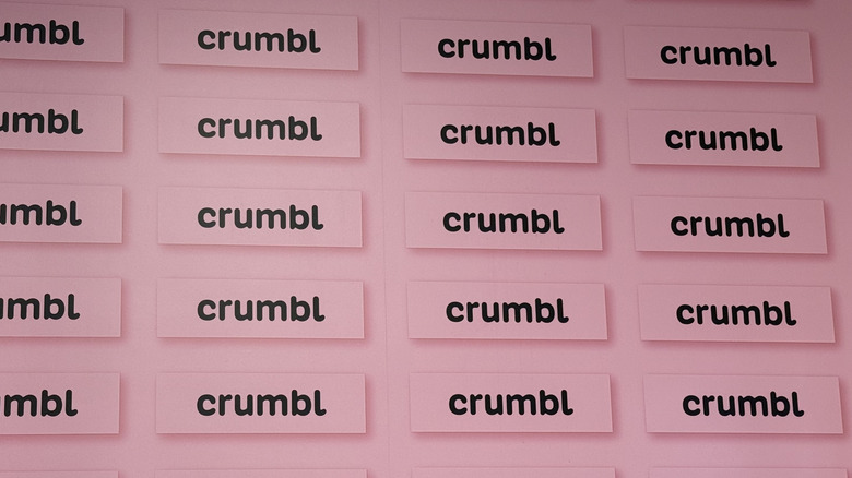A wall of Crumbl logos