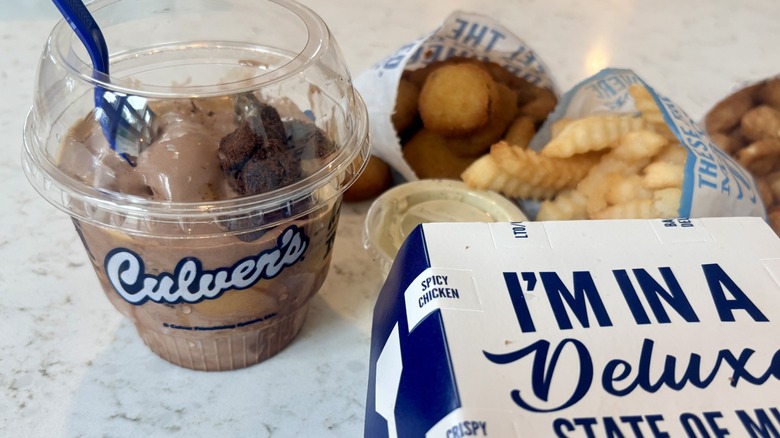 A takeout cup of Culver's new peanut butter fudge brownie frozen custard with fries and cheese curds