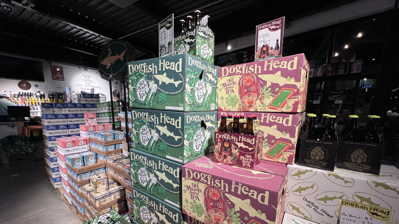 boxes of Dogfish Head 60 and 90 minute IPAs in a store, along with cartons of bottles