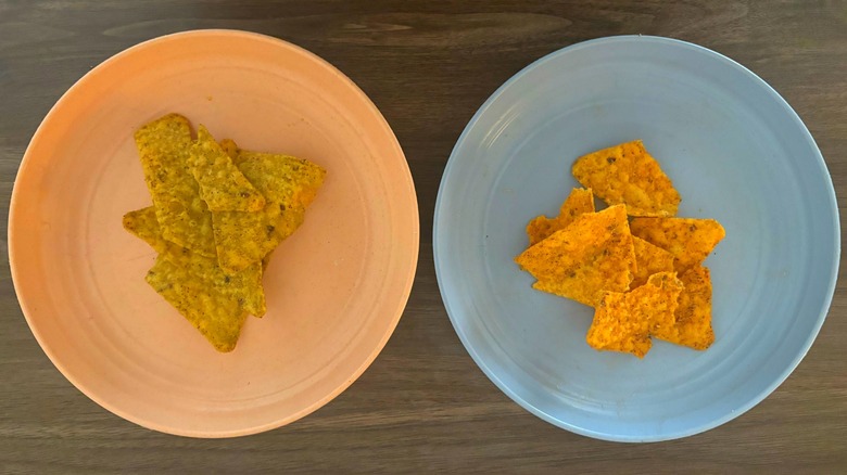 Two plates with different flavors of Doritos F1 Head2Head chips, including Late Night Loaded Taco and Chimichurri Lime