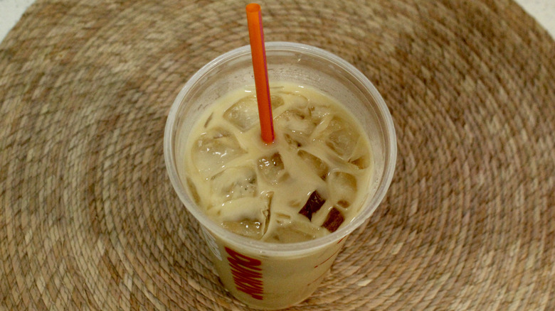 Overhead view of Dunkin' iced latte with straw